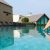 close-up-girl-s-leg-descends-into-pool-foot-touches-water-checks-water-temperature-before-swimming_0x800