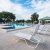 empty-chairs-by-swimming-pool-against-sky_0x800