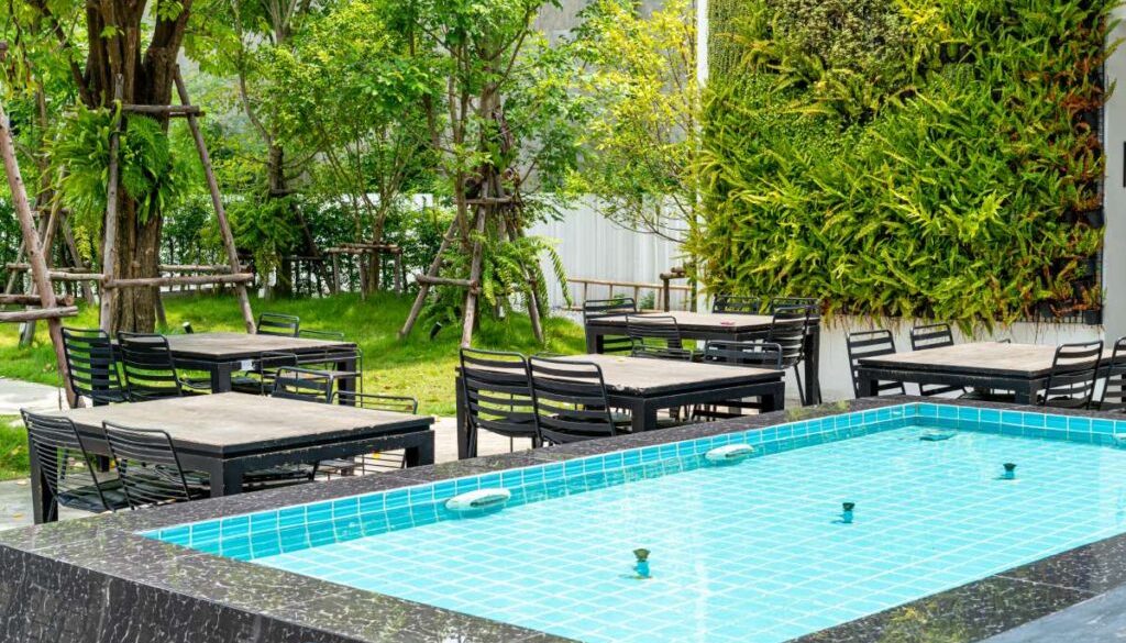 empty-outdoor-tables-chairs-near-fountain_0x800