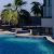 relaxing-afternoon-by-tranquil-poolside-surrounded-by-palm-trees-sunny-day_0x800