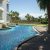 tranquil-oasis-with-swimming-pool-surrounded-by-palm-trees-sunny-day(1)_0x800