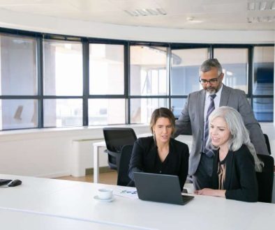 business-team-three-watching-presentation-pc-monitor-discussing-project-sitting-workplace-pointing-display-copy-space-business-meeting-concept_800x600