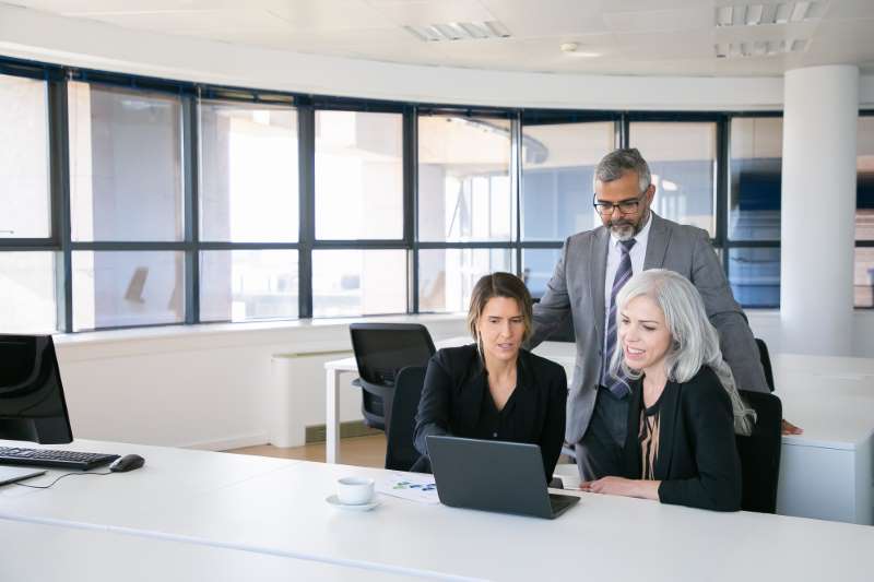 business-team-three-watching-presentation-pc-monitor-discussing-project-sitting-workplace-pointing-display-copy-space-business-meeting-concept_800x600