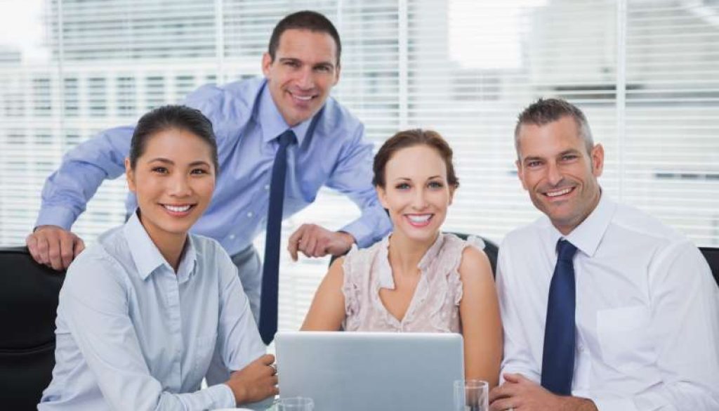 cheerful-colleagues-around-laptop-posing_800x600