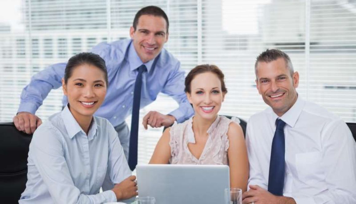 cheerful-colleagues-around-laptop-posing_800x600
