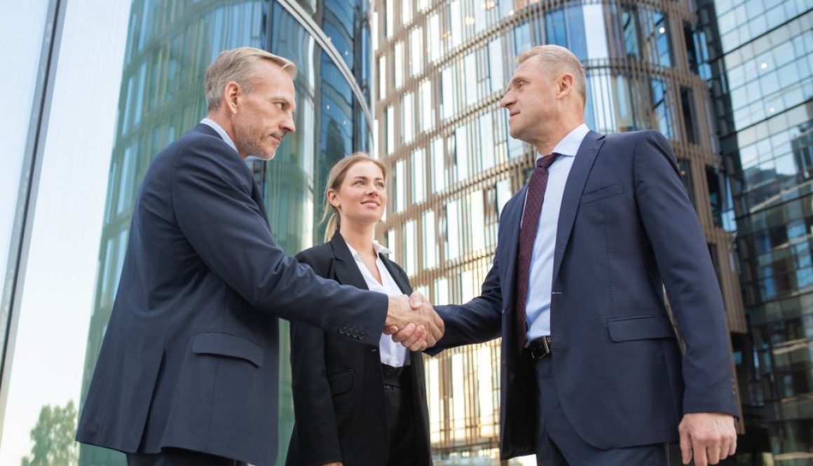 Confident middle-aged businessmen greeting each other