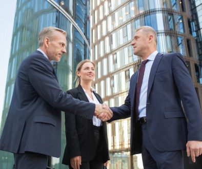 Confident middle-aged businessmen greeting each other