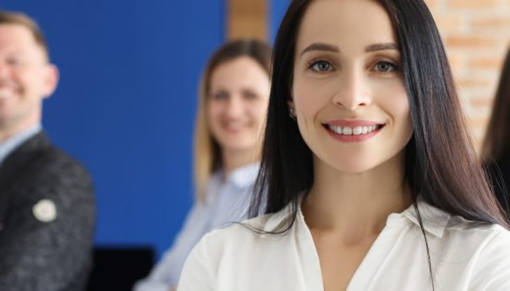 Confident people posing in company office
