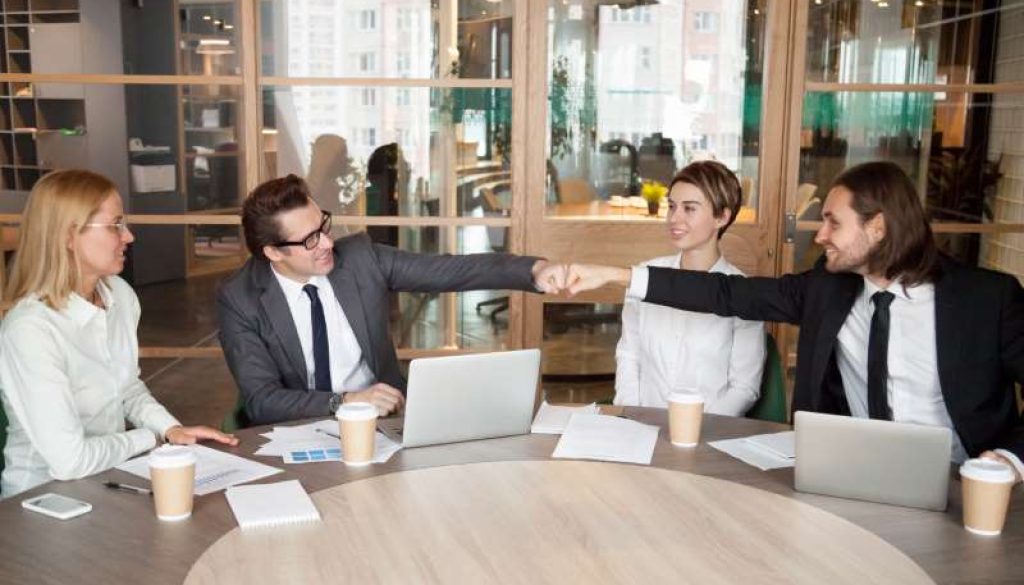 friendly-male-colleagues-partners-fist-bumping-team-meeting_800x600