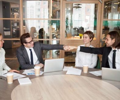 friendly-male-colleagues-partners-fist-bumping-team-meeting_800x600