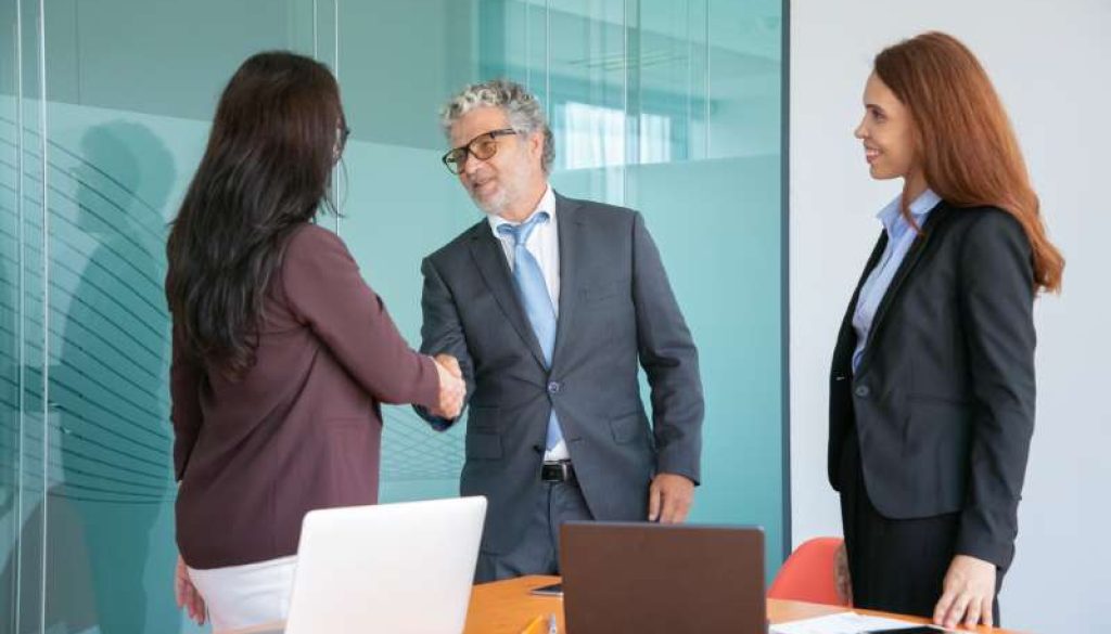 grey-haired-senior-manager-handshaking-greeting-businesswoman_800x600