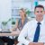 happy-businessman-smiling-camera-with-colleagues_800x600