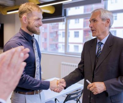 smiling-businesspeople-shaking-hands-meeting-office_800x600