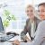 smiling-businesswomen-looking-camera-working-together_800x600