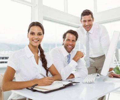 three-smiling-business-people-office-desk_800x600